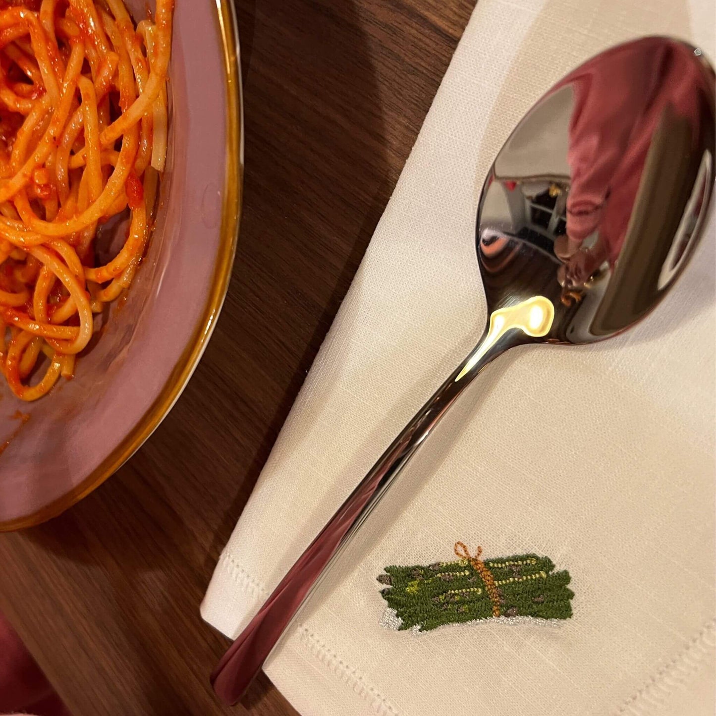 White linen napkin size 40x40cm embroidered illustration by Stefanie Vietor of aspargus in dinner table setting